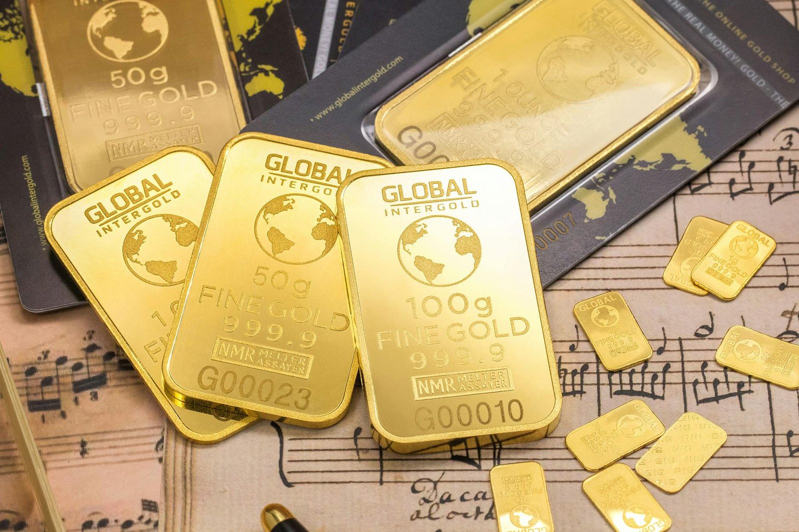 Physical gold bars and coins stored in a home safe and bank vault