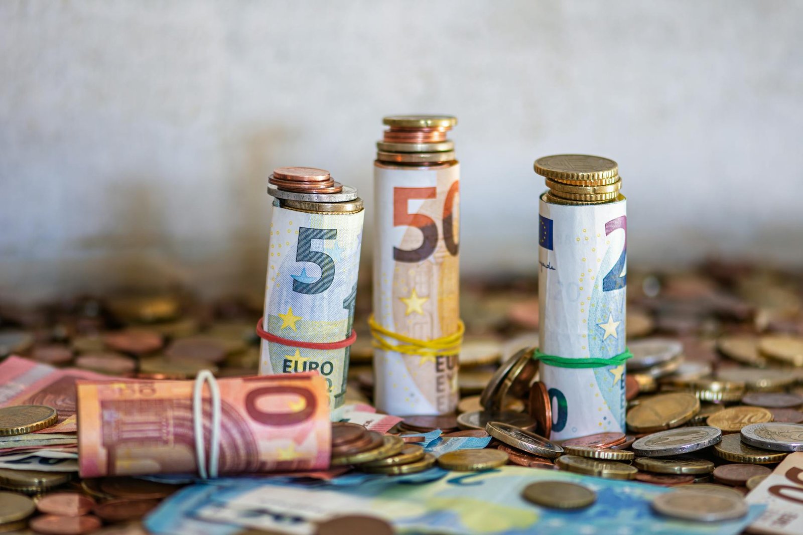 Gold coins next to rising inflation chart showing wealth protection